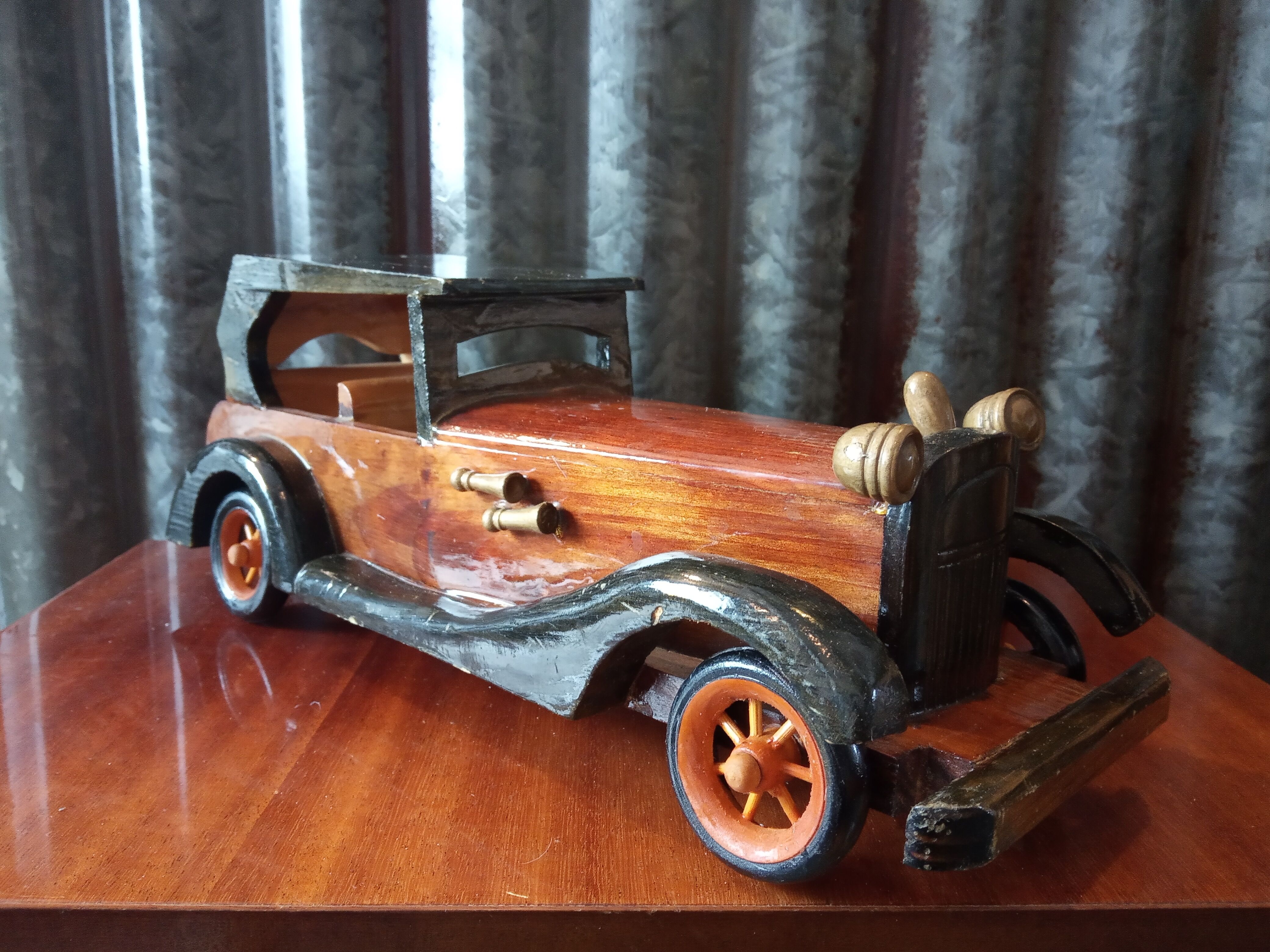 Toy car made of varnished wood