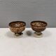 A set of ceramic candle holders in earthy colours.