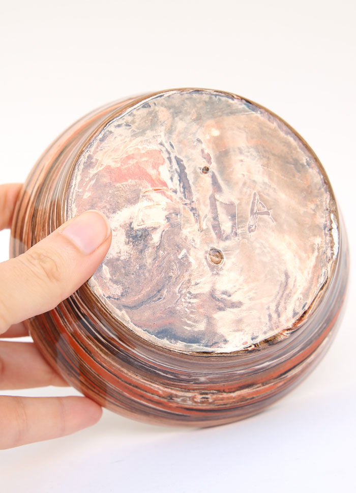 Terracotta cup in mixed earth