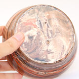 Terracotta cup in mixed earth