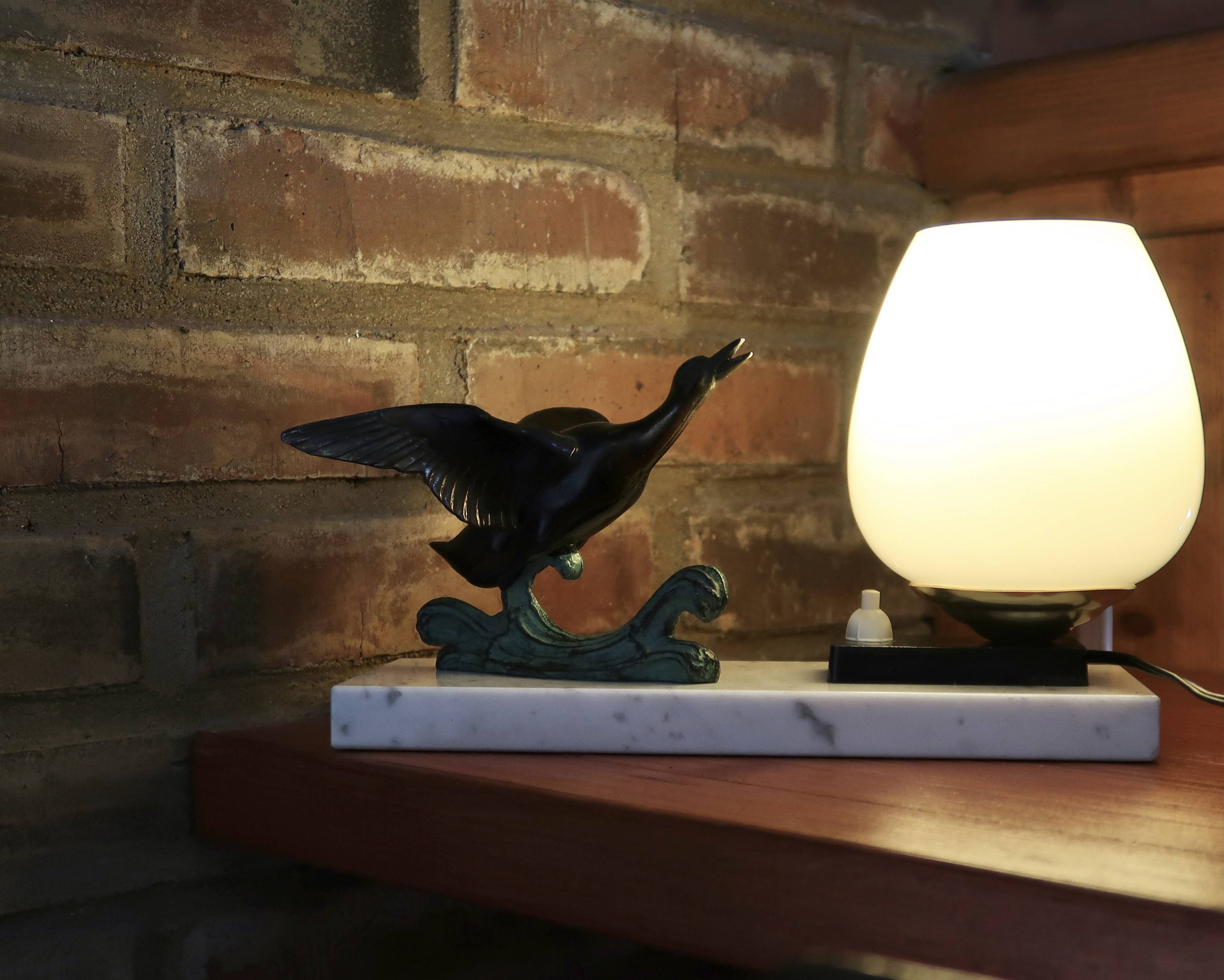 Art Deco lamp decorated with a flying duck, marble base, 1930s.