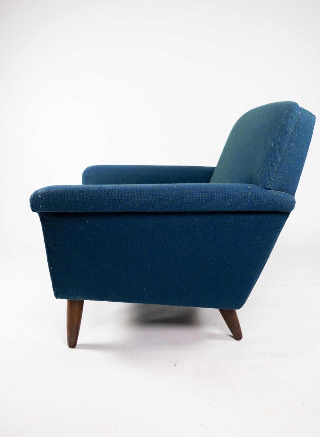 Armchair upholstered with dark blue wool fabric and legs in dark wood, of danish design, 1960s