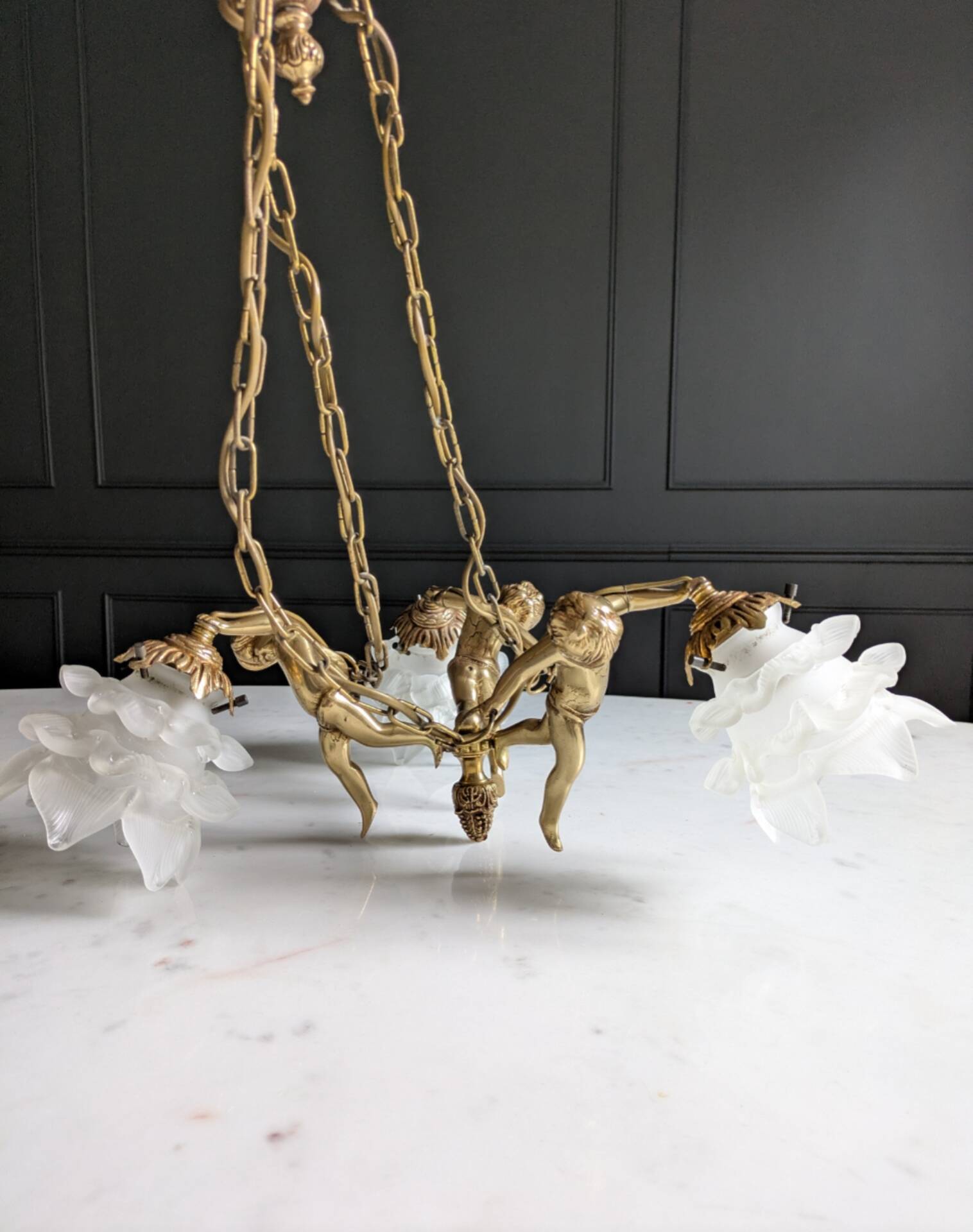 Vintage chandelier with cherubs and frosted glass flowers.