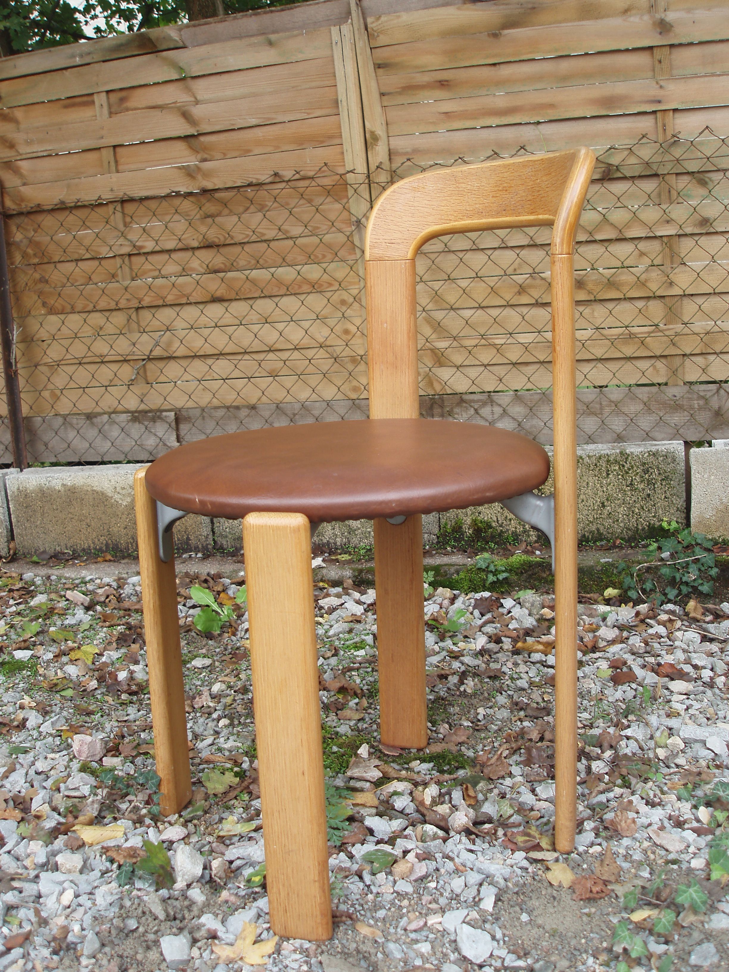Pair of chairs by Swiss designer Bruno Rey in wood and brown skai