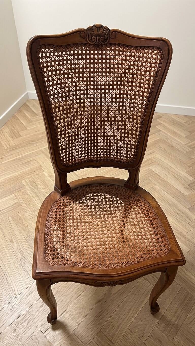 Oval dining table and 6 caned chairs in Louis XVI style made of wood.