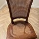 Oval dining table and 6 caned chairs in Louis XVI style made of wood.