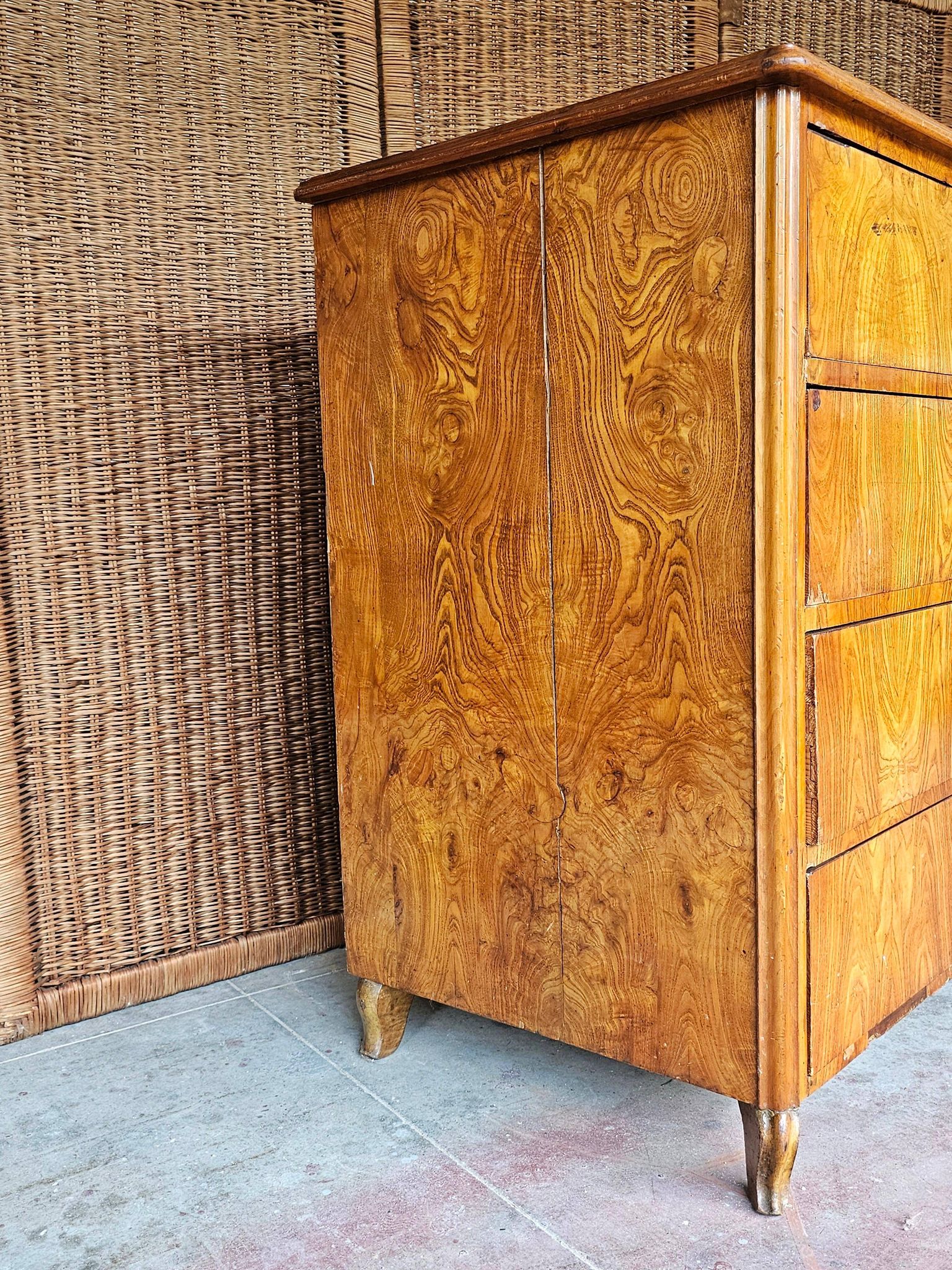 Large antique Biedermeier-style chest of drawers with wood grain.