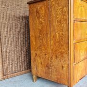 Large antique Biedermeier-style chest of drawers with wood grain.