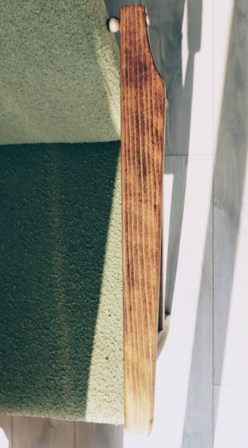 Mid-century modern armchair in olive green bouclé design by H. Lis.