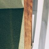 Mid-century modern armchair in olive green bouclé design by H. Lis.