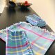 Vintage tablecloth & napkins, blue with multicoloured stripes.