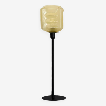 Table lamp with a vintage art deco style yellow lampshade and a black base