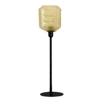Table lamp with a vintage art deco style yellow lampshade and a black base