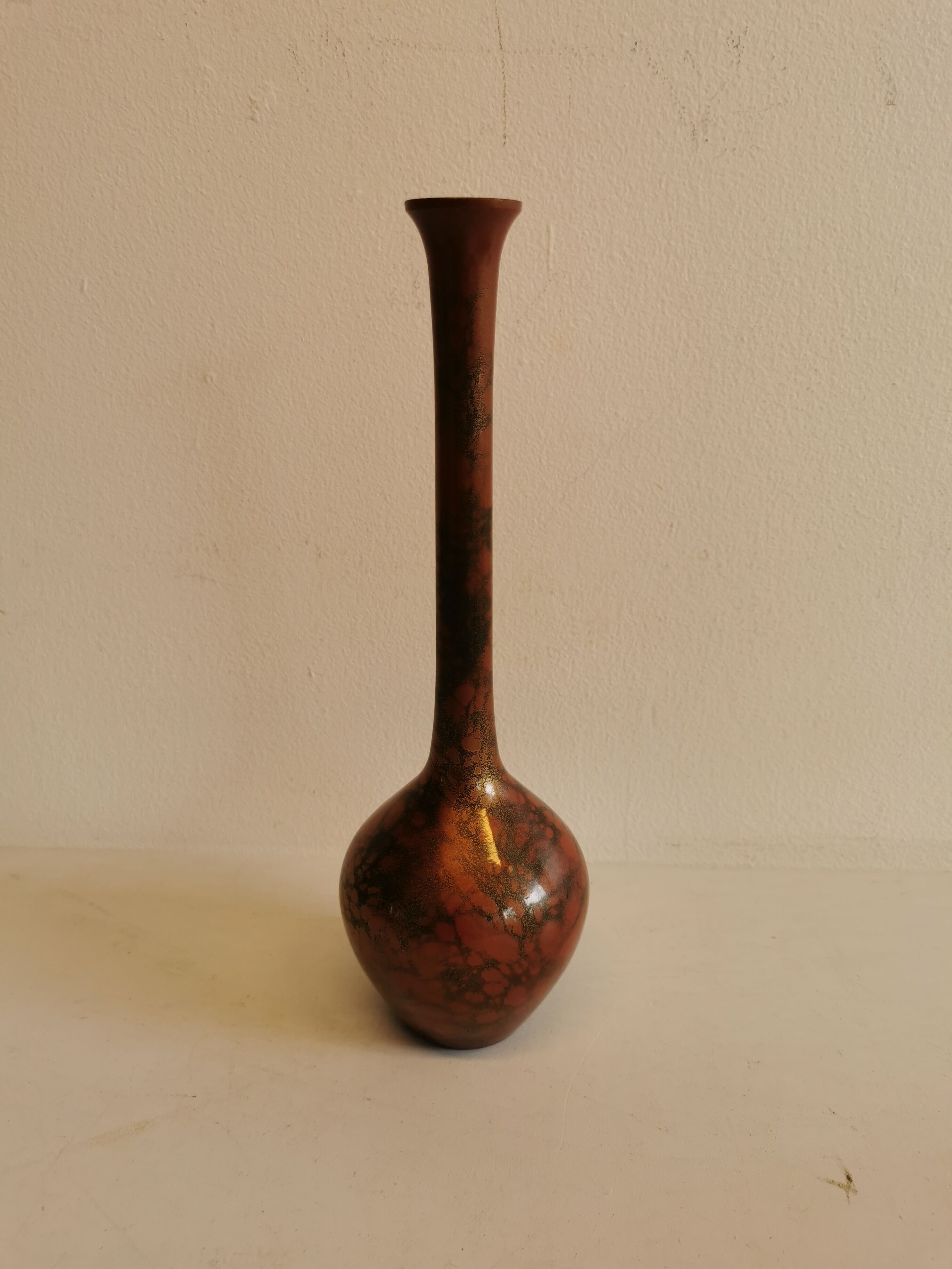 Slim vase with metallic finish.