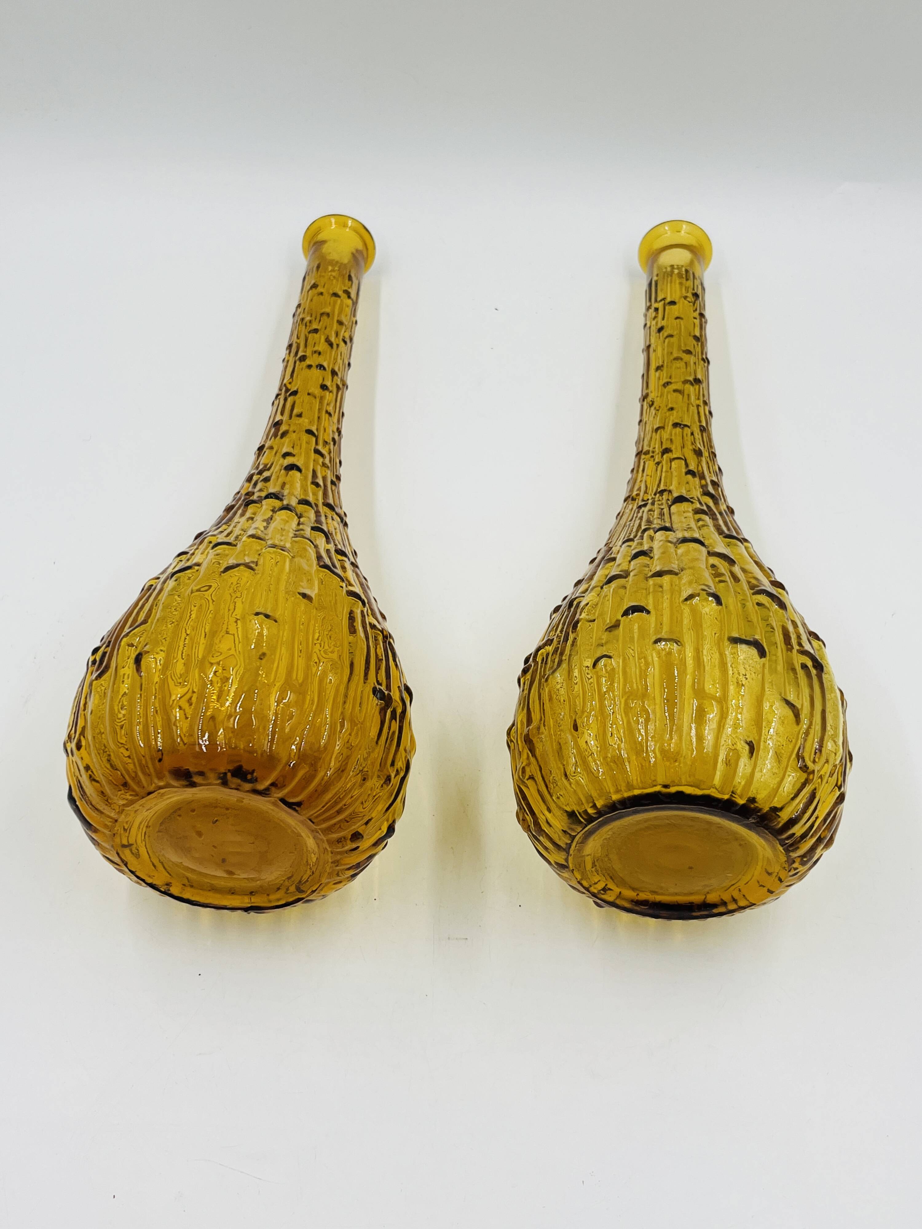 Set of two vintage textured amber glass Empoli bottles.