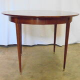 Mahogany round table with 4 extensions from the 1950s