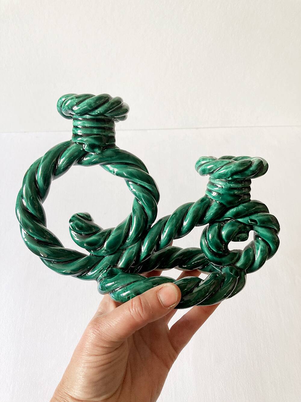 Two-armed candlestick in green glazed ceramic, braided effect