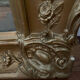 Large antique baroque mirror with angel decorations.
