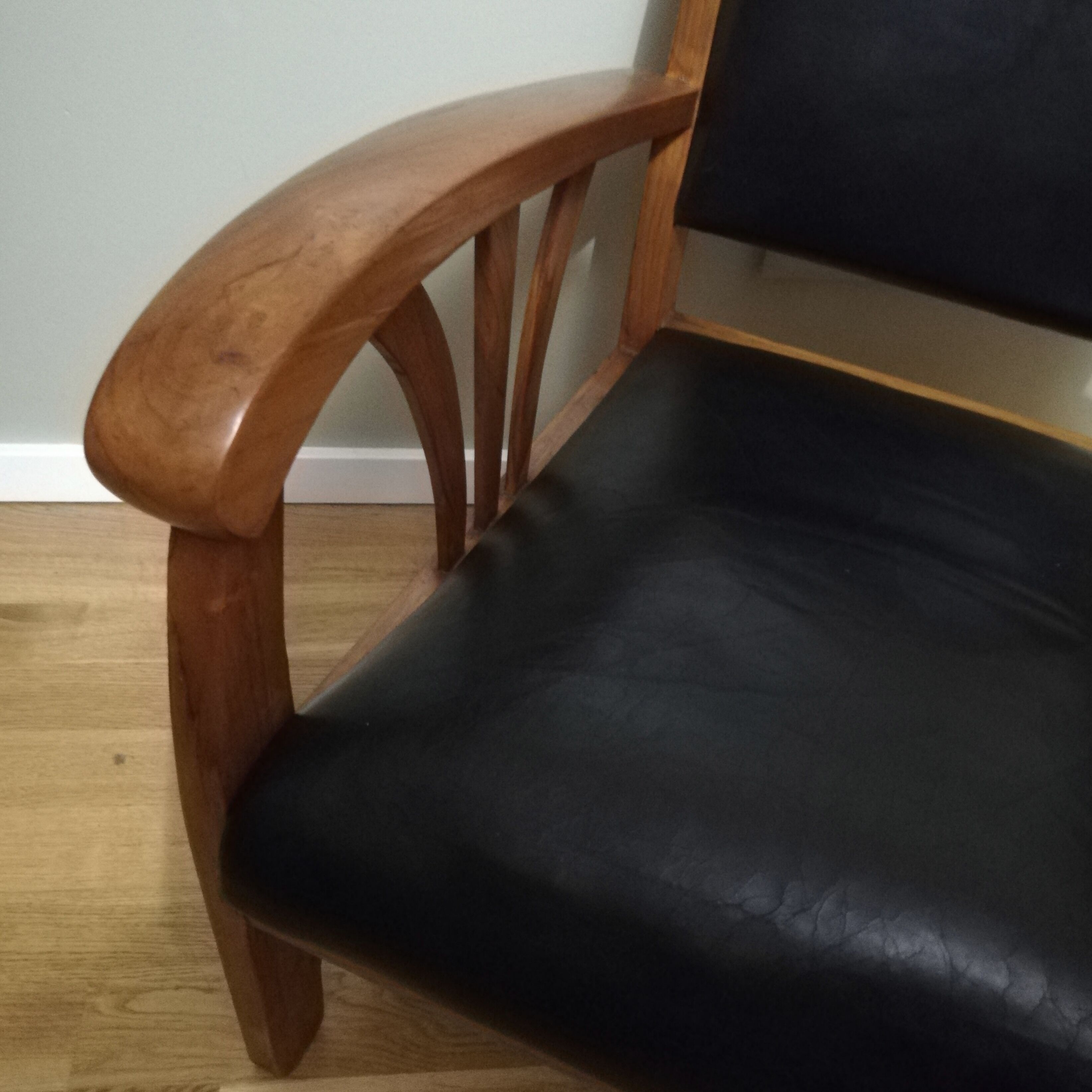 Colonial armchair in teak and black leather