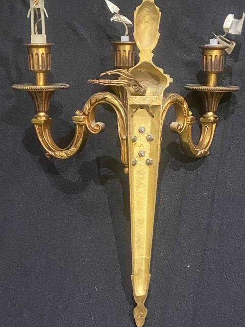 Pair of gilt bronze wall sconces with three lights in the Louis XVI style.