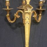 Pair of gilt bronze wall sconces with three lights in the Louis XVI style.