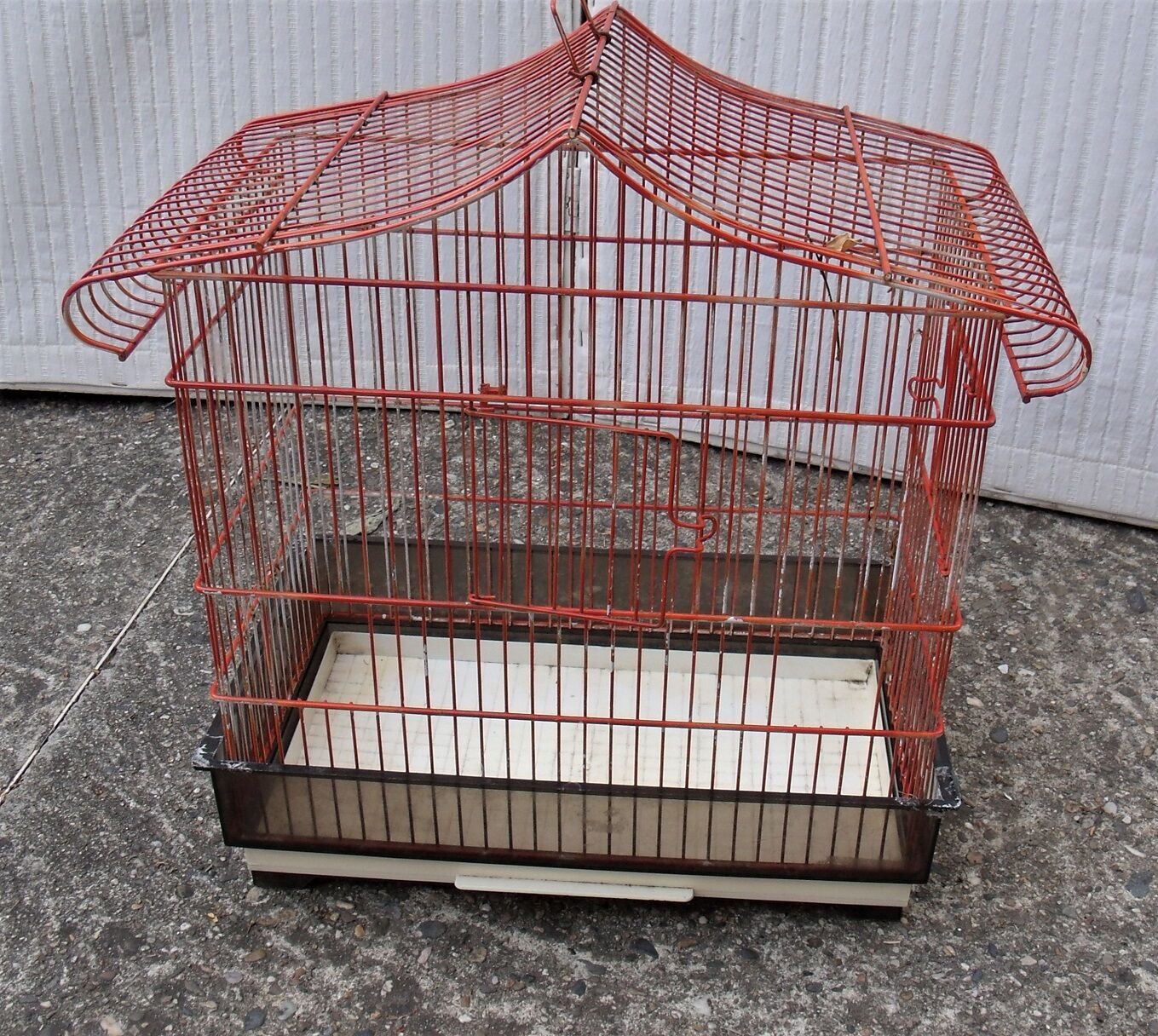 Old red metal birdcage