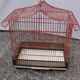 Old red metal birdcage