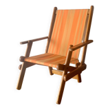 Old foldable beach seat in wood and canvas for children