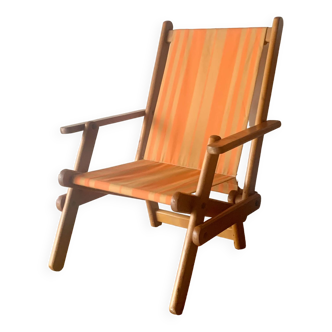 Old foldable beach seat in wood and canvas for children