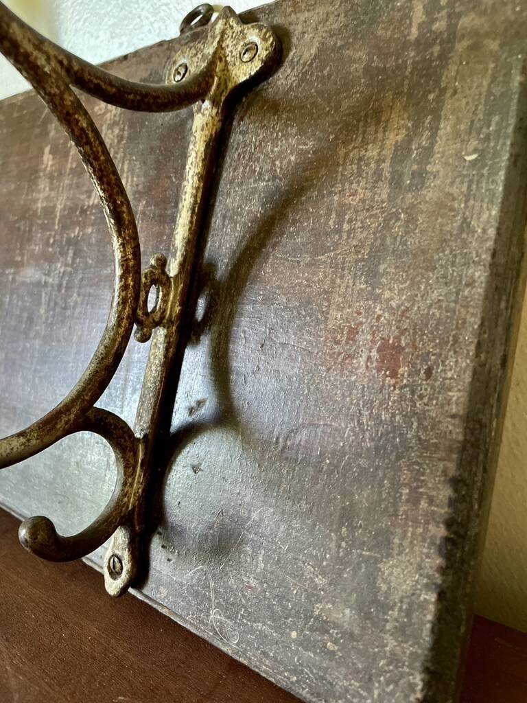 Patinated wood and metal coat rack from the 1950s.