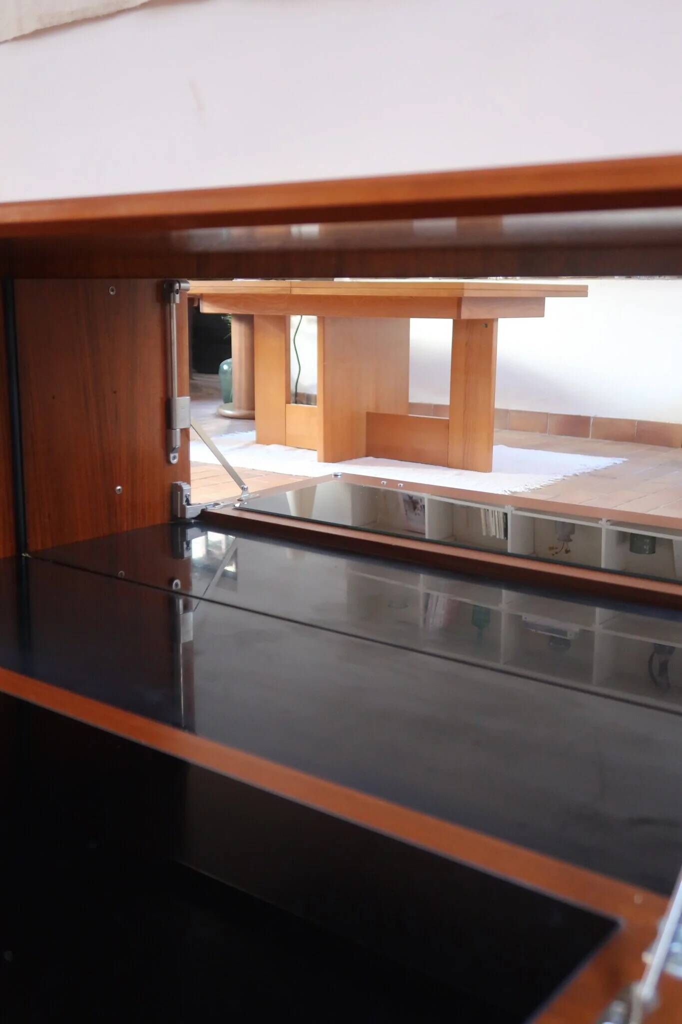 Vintage teak bar cabinet with black glass interior.