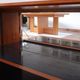 Vintage teak bar cabinet with black glass interior.