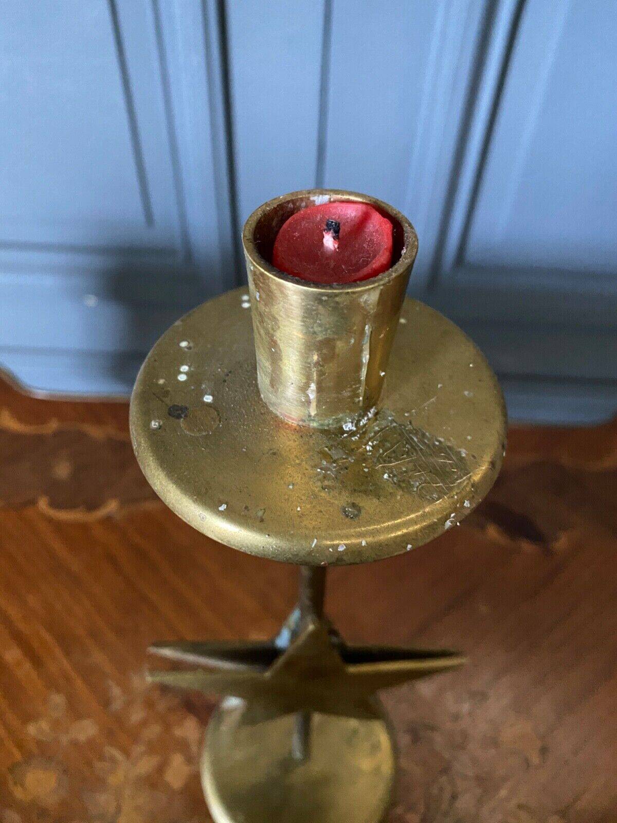 Pair of brass candlesticks decorated with 20th century stars