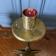 Pair of brass candlesticks decorated with 20th century stars