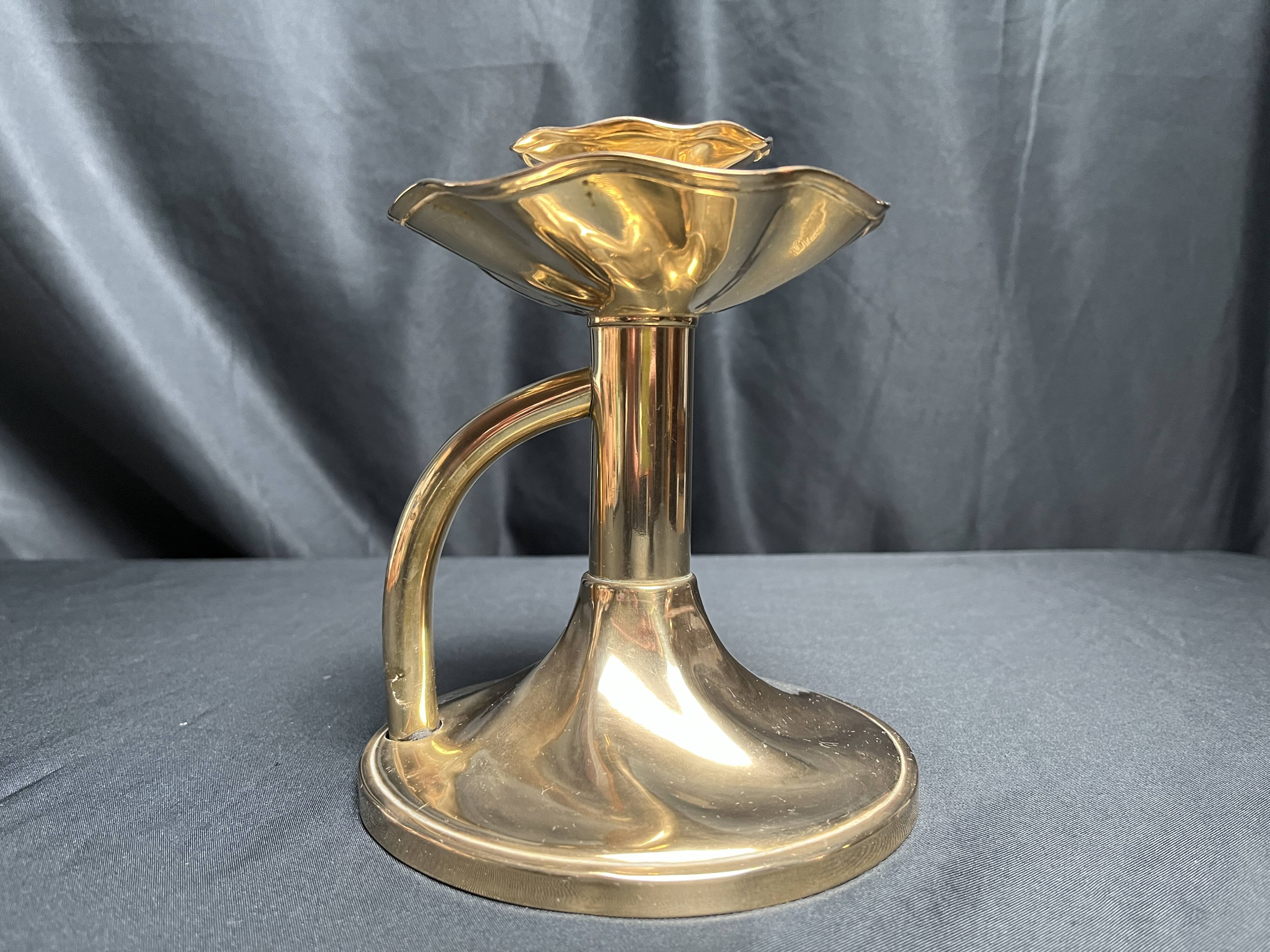 Brass candlestick in a fluted shape from the early 20th century.