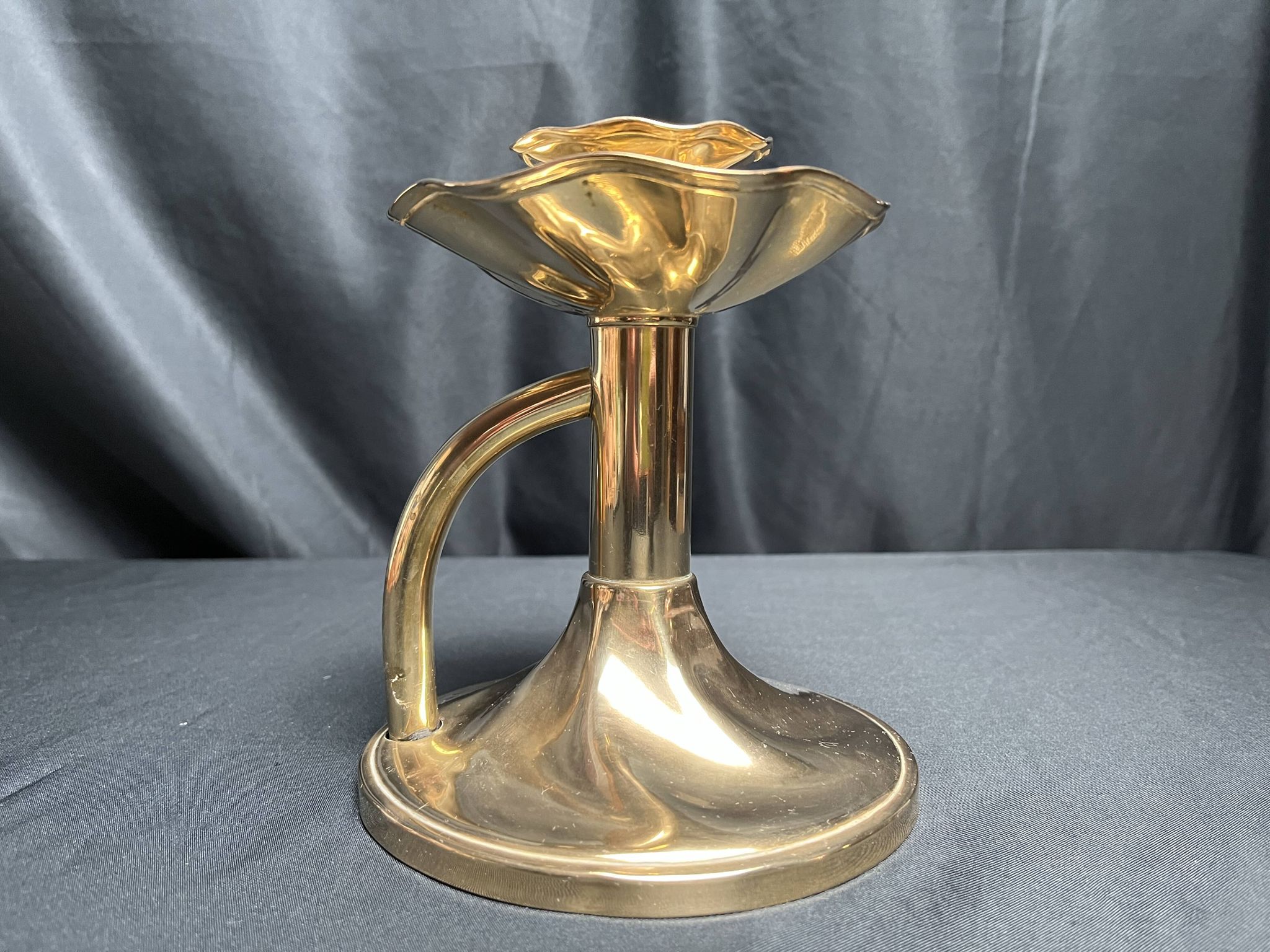 Brass candlestick in a fluted shape from the early 20th century.