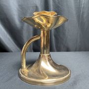 Brass candlestick in a fluted shape from the early 20th century.