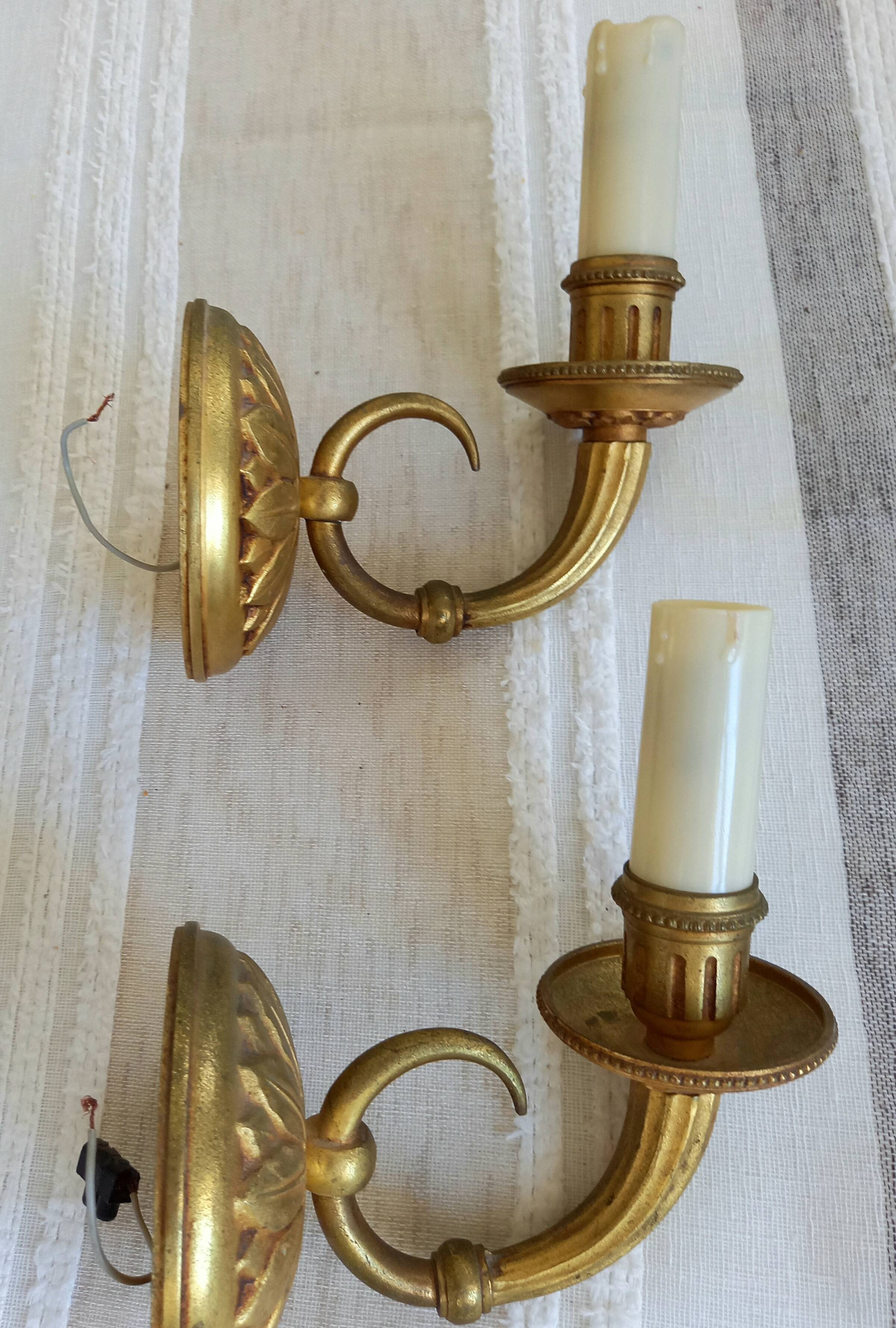 Electrified bronze gold wall sconces... in pairs.