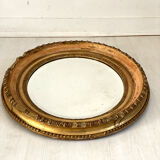 Oval mirror in wood and gilded stucco