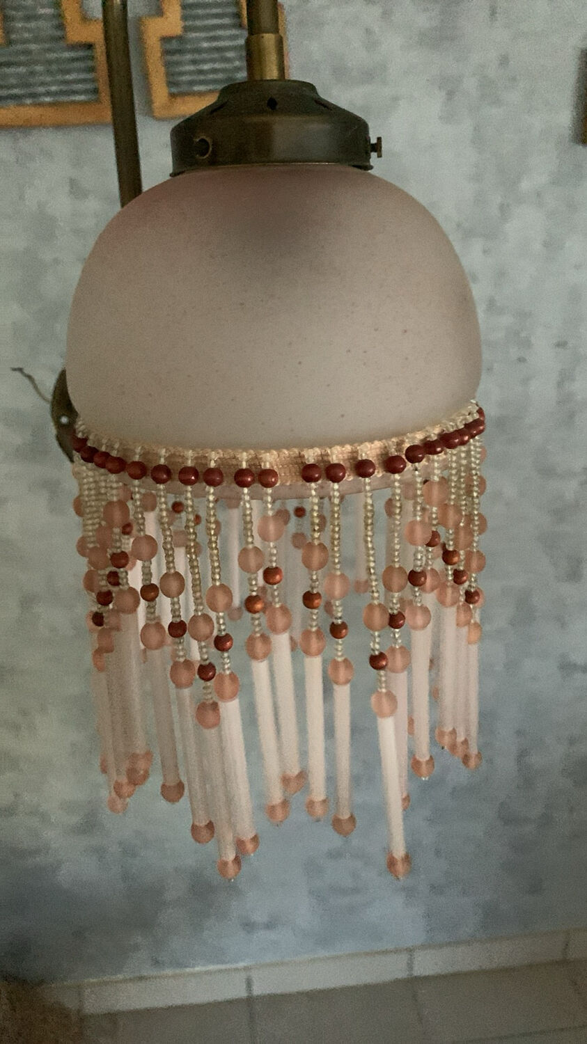 Pair of wall sconces in pink glass and pendants.