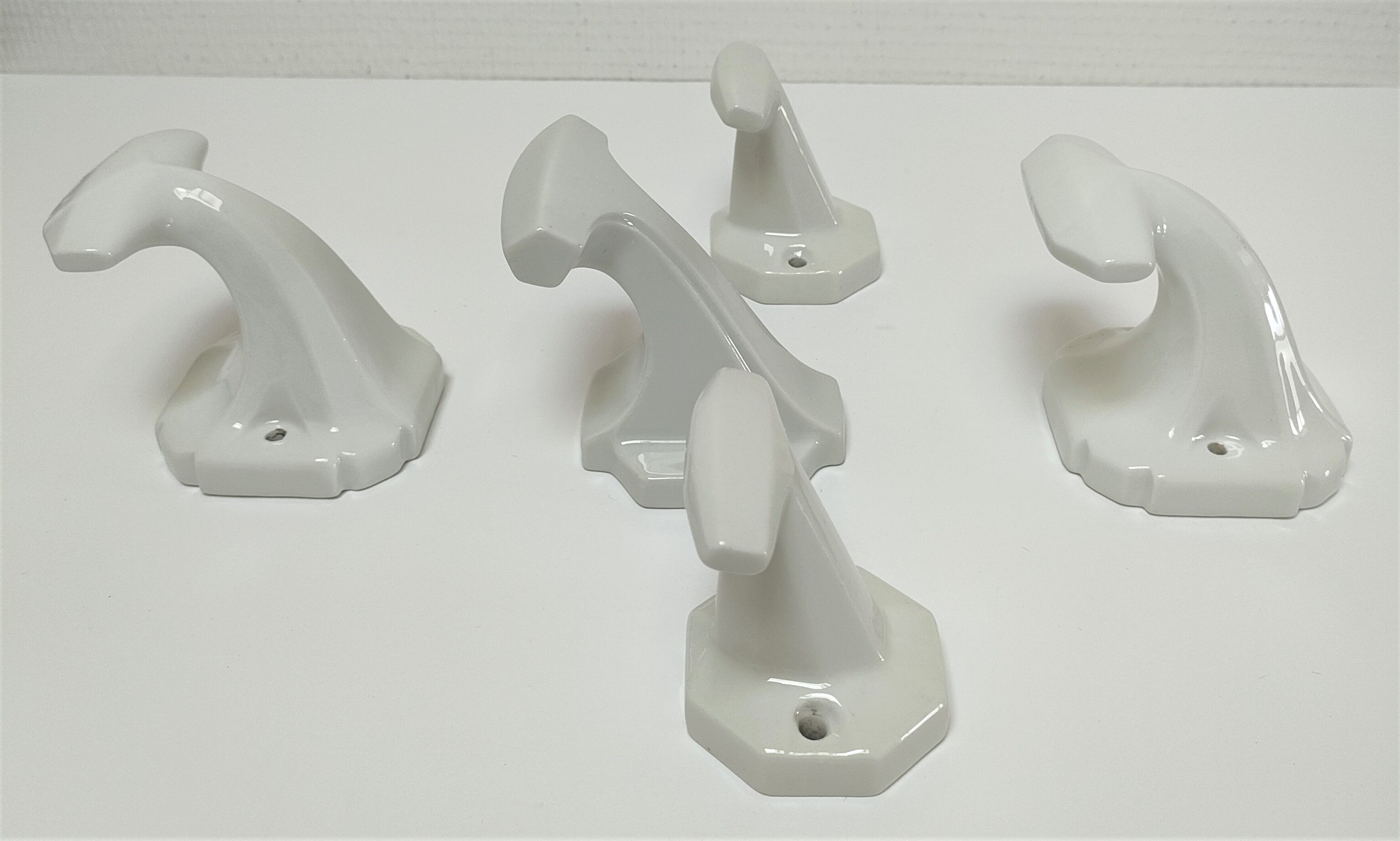 Five art deco white porcelain hooks