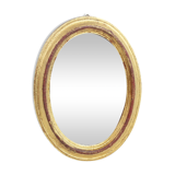 Golden oval mirror