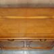 Vintage buffet made of mottled yew wood with three doors and four drawers.