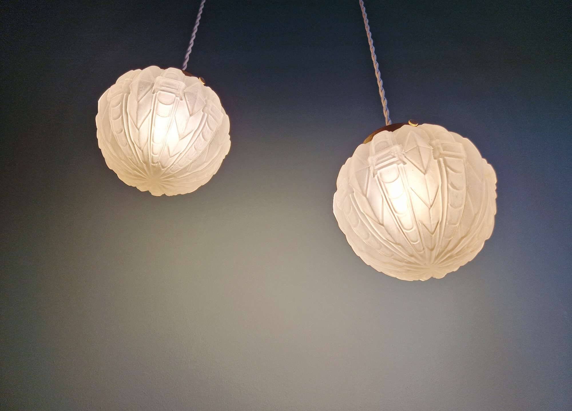 Pair of Art Deco pendant lights in pressed molded satin glass, 1920-30
