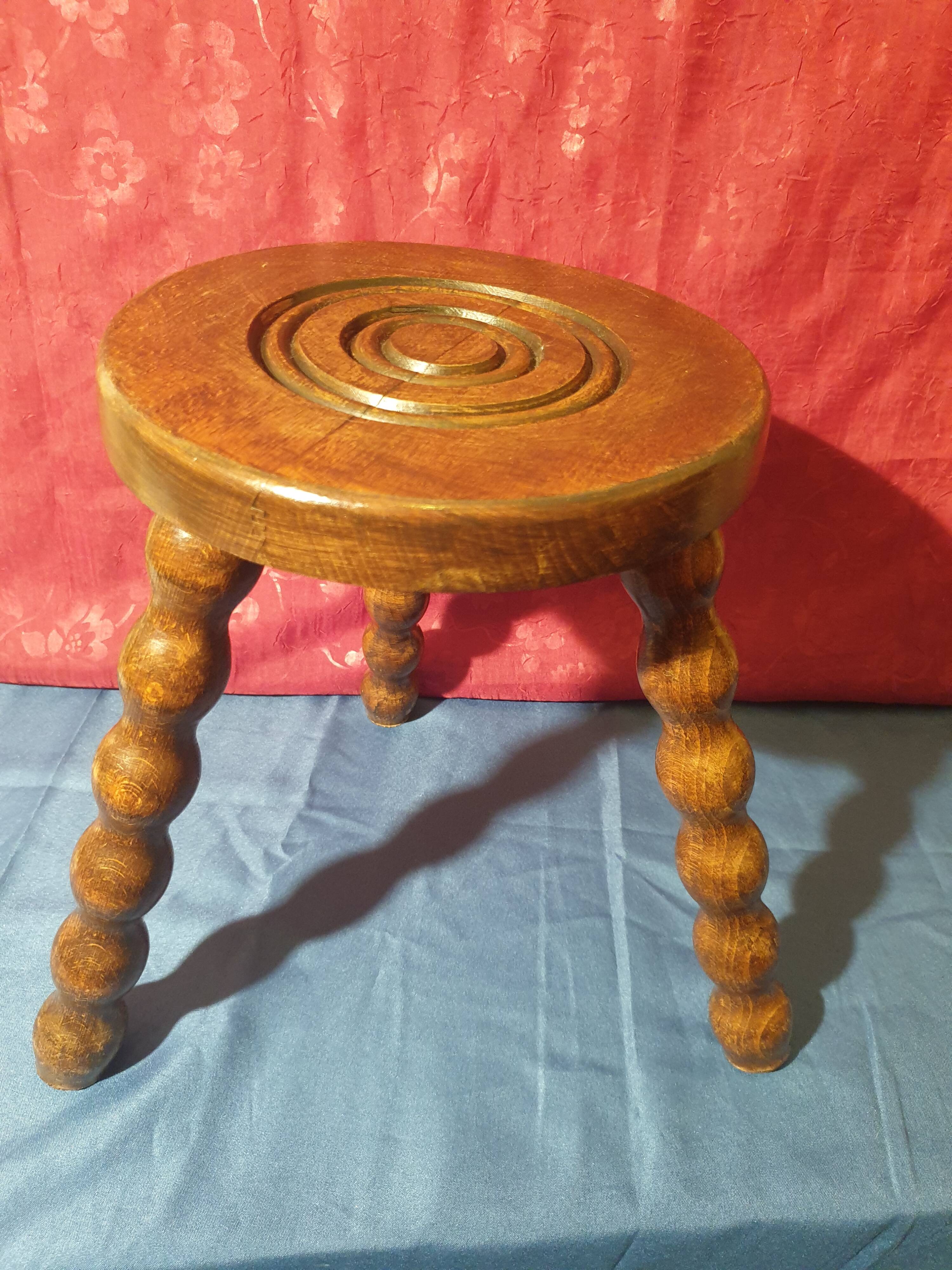 Wooden milking stool with twisted legs