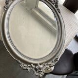 Beveled oval mirror in wood and stucco
