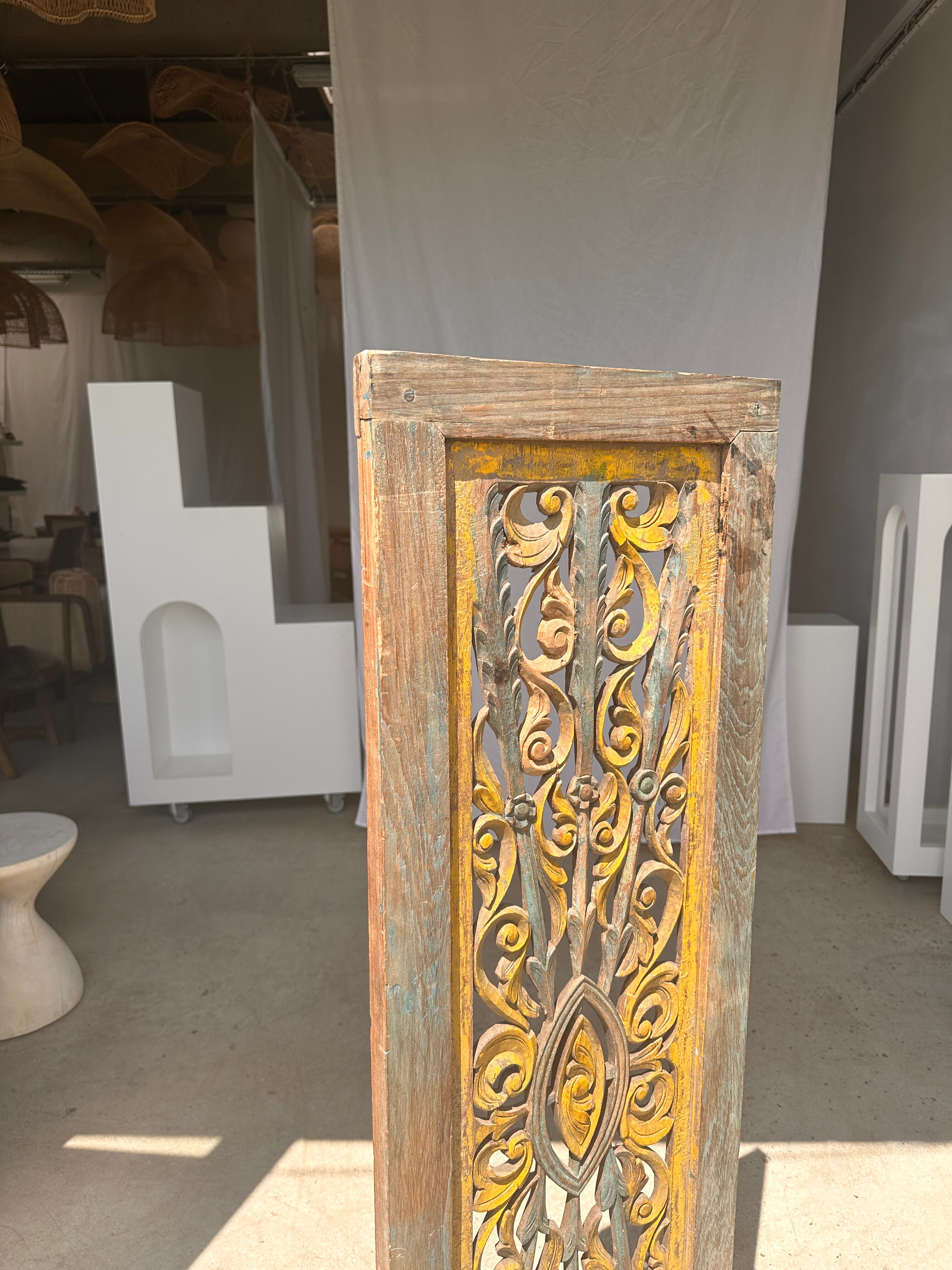 Rectangular Indonesian construction element with blue and yellow plant in carved wood