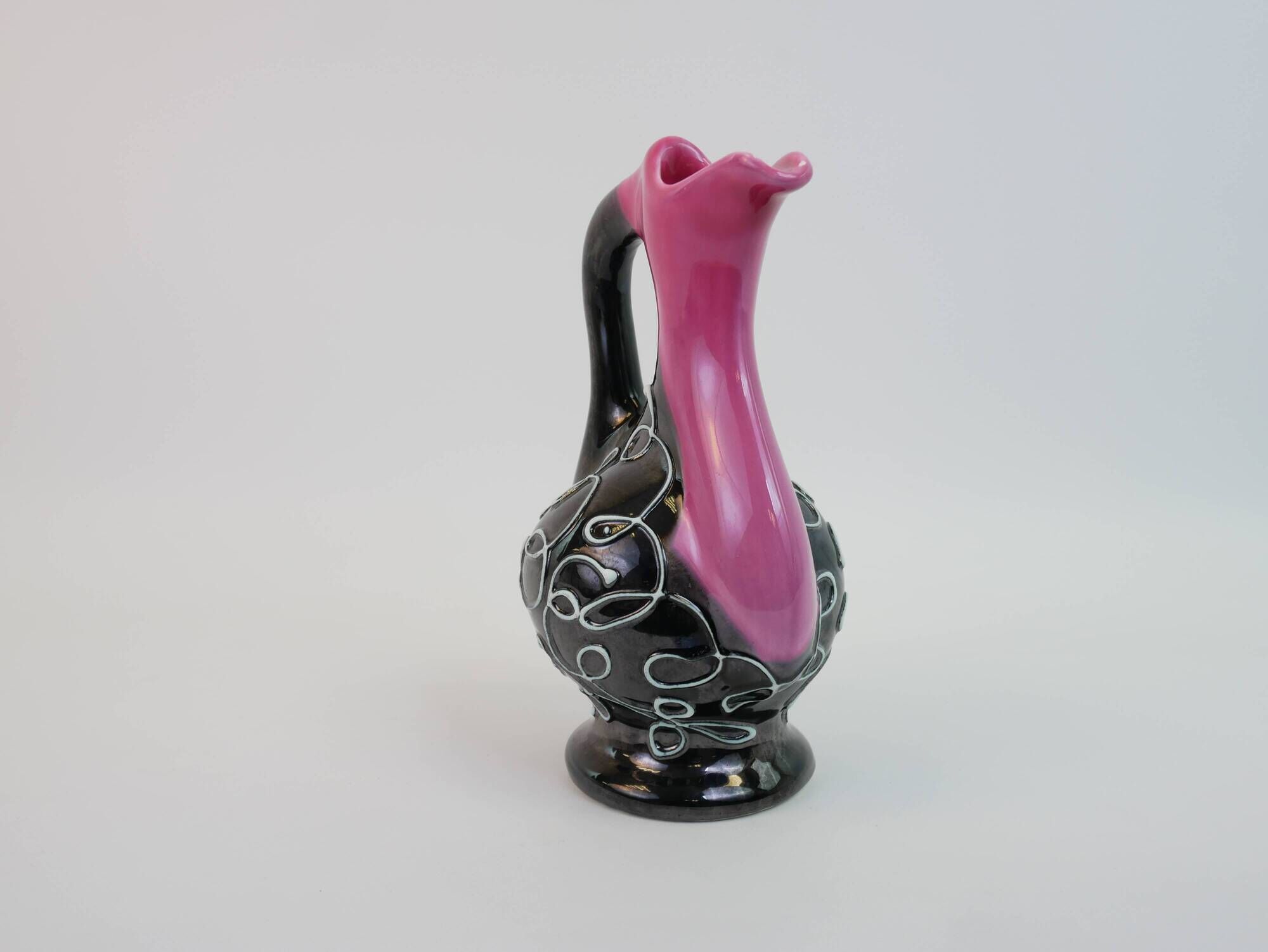 Black and pink Vallauris carafe with white relief patterns