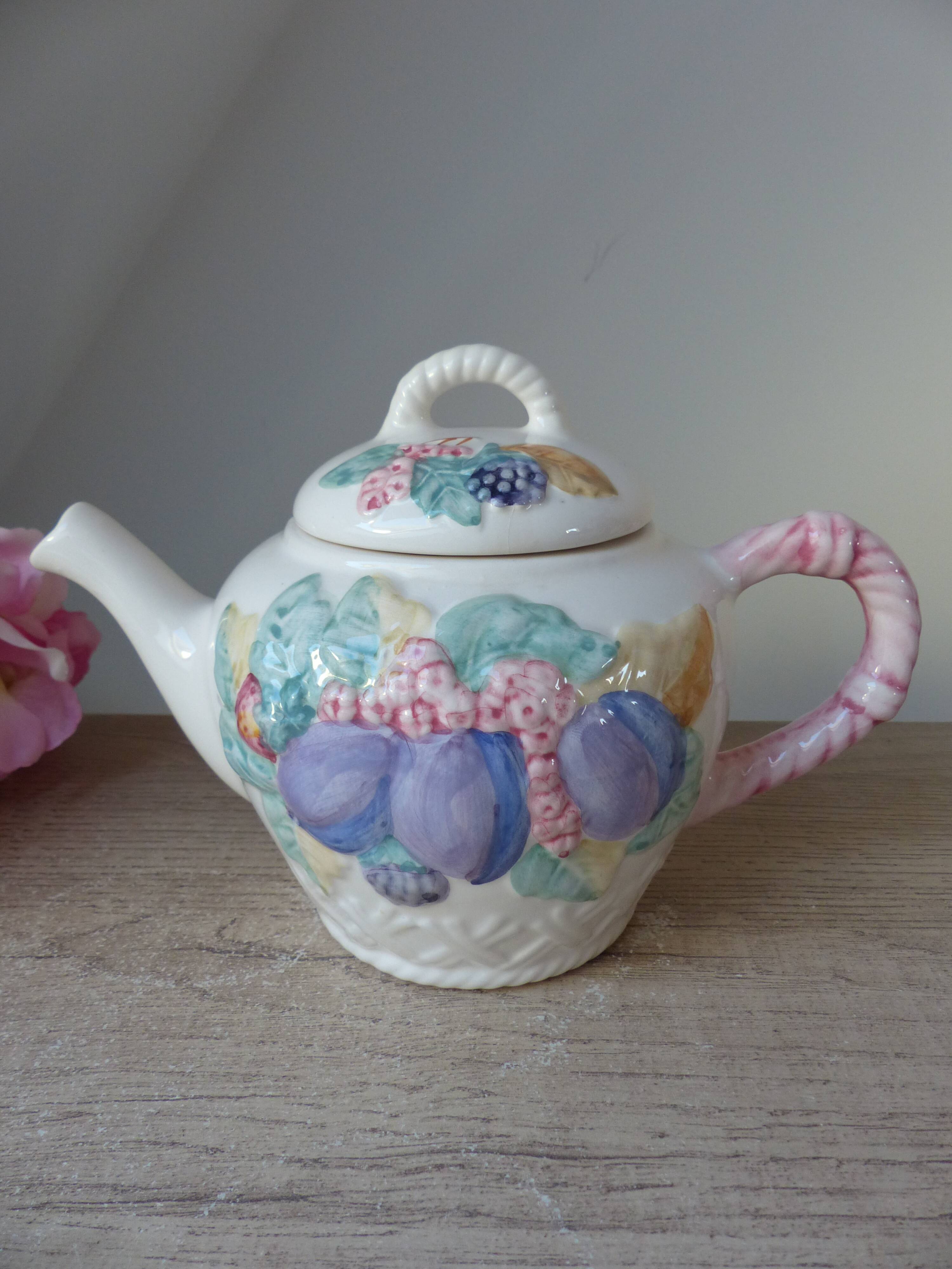 Old ceramic teapot in the shape of a basket of fruits from the garden