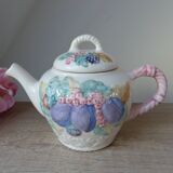 Old ceramic teapot in the shape of a basket of fruits from the garden